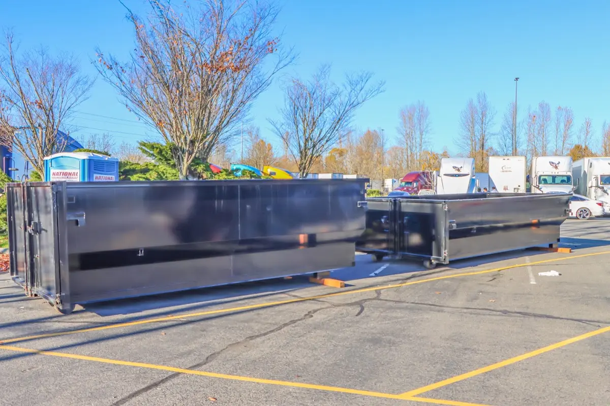 Professional dumpster rental service with roll-off container on residential driveway in South Kingstown